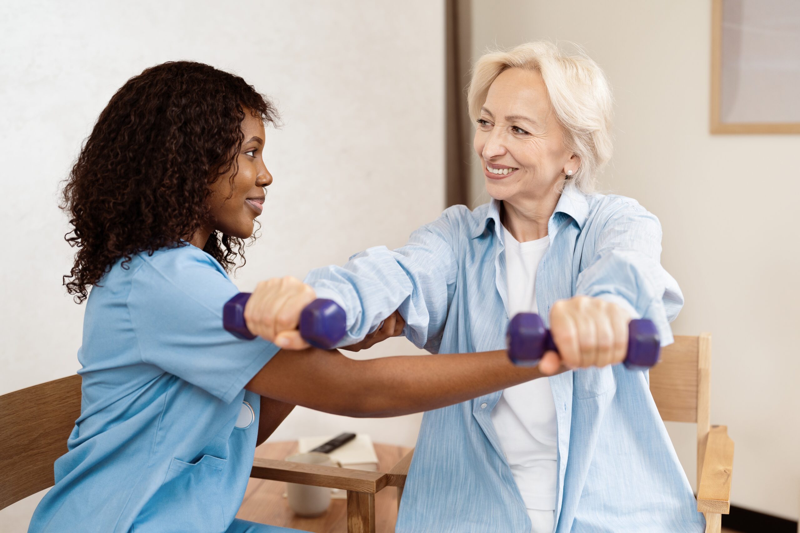 Calgary exercise therapy session with physiotherapist and patient using dumbbells.